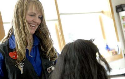 
Penny McGuire, of Mane Reflections Hair Salon in Sandpoint, shares a laugh with a client.  She has been the driving force behind her salon's donations to Locks of Love. 
 (The Spokesman-Review)