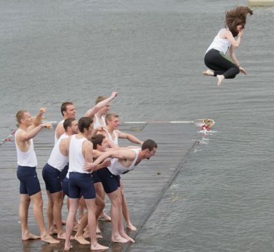Washington men's varsity team toss their coxswain, Michelle Darby into Lake Washington after winning the Windemere Cup over Syracuse and Oxford on the Montlake Cut in Seattle on Saturday, May 1, 2010. (Jim Bates / The Seattle Times)