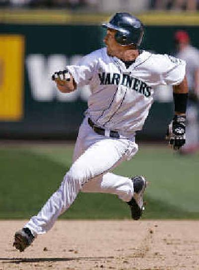 
Seattle catcher Miguel Olivo has worked intensively with Mariners catching coordinator Roger Hansen over the winter to improve his game and prepare himself to become Seattle's starting catcher in 2005.
 (Associated Press / The Spokesman-Review)