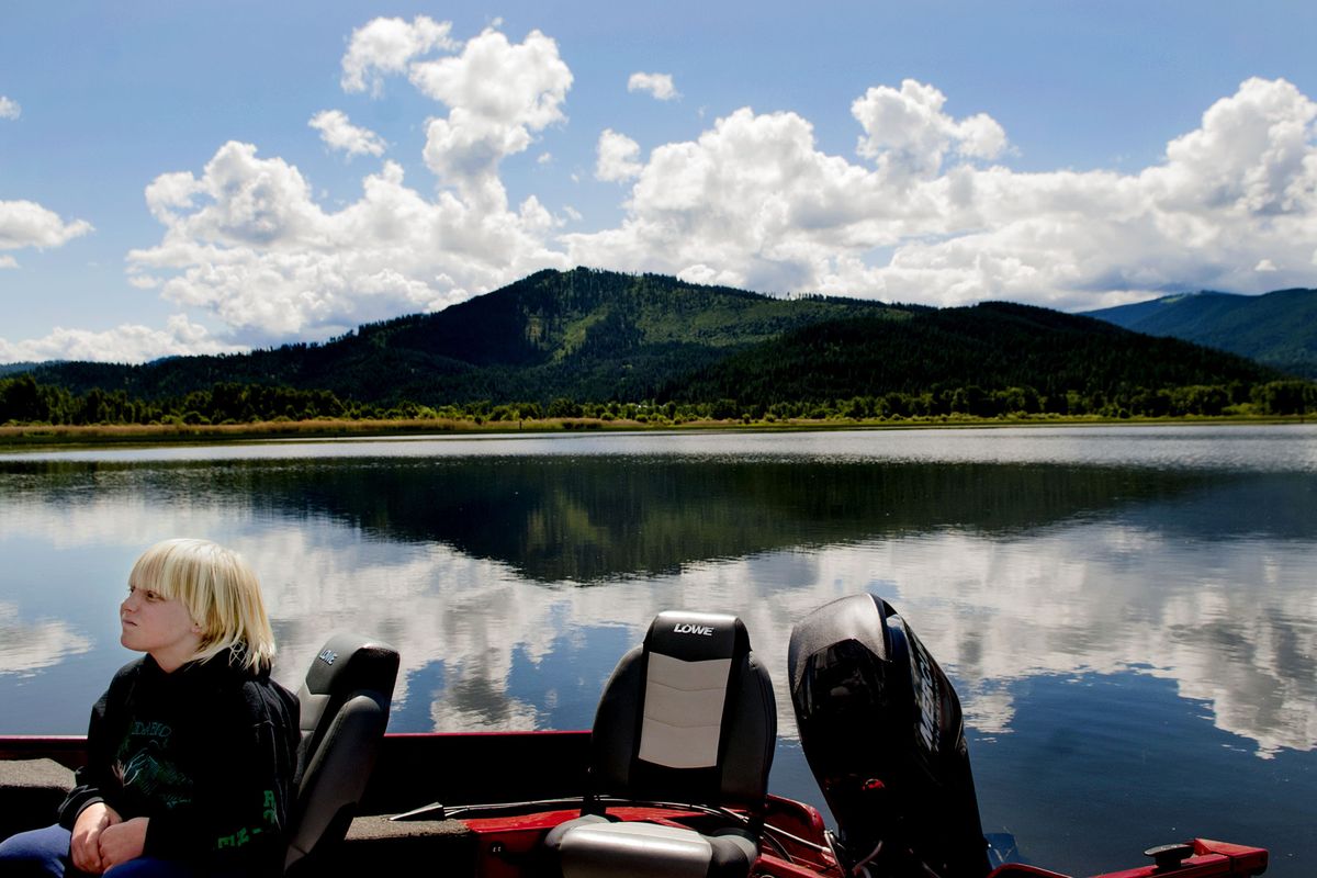 Eleven-year-old Coby Robnett waits for his dad to pull the boat out of Killarney Lake after fishing Thursday. A new campaign from the state and the Panhandle Health District is called “Play Clean,” reminding people to be smart about recreation in the Coeur d’Alene Basin. (Kathy Plonka)