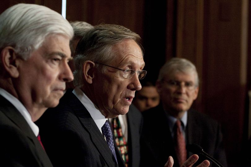 Senate Majority Leader Harry Reid, center, accompanied by Senate Banking Committee Chairman Sen. Christopher Dodd, left, and others, speaks during a Democratic health care rally Tuesday on Capitol Hill in Washington. Associated Press photos (Associated Press photos)