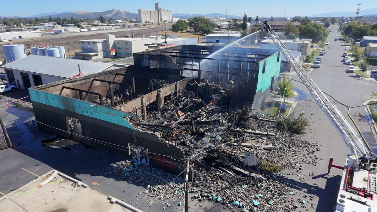 The warehouse that once served Tormino’s Sash and Glass is left in rubble on Thursday after an overnight fire Wednesday destroyed the building at the corner of North Madelia and East Riverside Avenue. (Jesse Tinsley/THE SPOKESMAN-REVI)