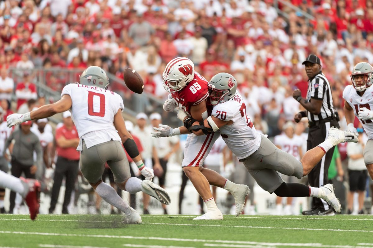 Washington State Cougars defensive end Quinn Roff forces Wisconsin Badgers tight end Clay Cundiff (85) to fumble, which Washington State Cougars defensive back Sam Lockett III (0) recovers during the fourth quarter at Camp Randall Stadium in Madison, WI on Saturday, September 10, 2022.  (Kirsten Schmitt/For The Spokesman-Review)