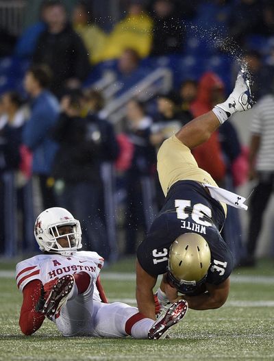 Navy fullback Shawn White (31) gets upended during the second half of Navy’s upset victory over Houston in Annapolis, Maryland. Navy won 46-40. (Nick Wass / Associated Press)