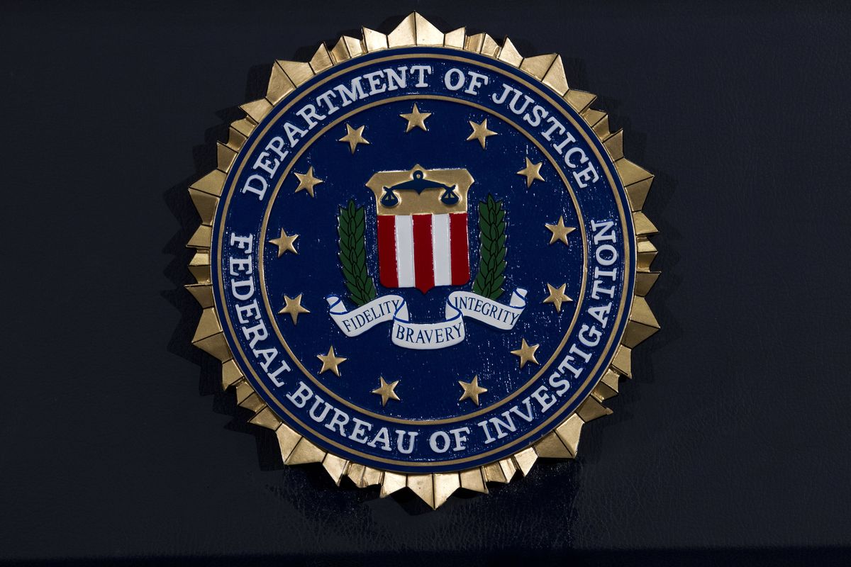 FILE - This Thursday, June 14, 2018, file photo, shows the FBI seal at a news conference at FBI headquarters in Washington. In an alert Wednesday, Oct. 28, 2020, the FBI and other federal agencies warned that cybercriminals are unleashing a wave of data-scrambling extortion attempts against the U.S. healthcare system that could lock up their information systems just as nationwide cases of COVID-19 are spiking.  (Jose Luis Magana)