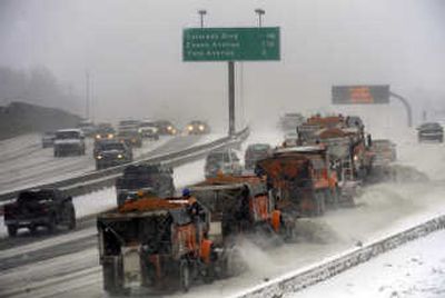 
Snowplows clear Interstate 25 in Denver. The storm forced numerous flight cancellations Thursday.Associated Press
 (Associated Press / The Spokesman-Review)