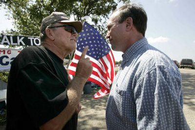 
Sheehan supporter Bill Demski (left) tries to make a point Thursday with Bush supporter John Hallowell in Crawford, Texas. 
 (Associated Press / The Spokesman-Review)