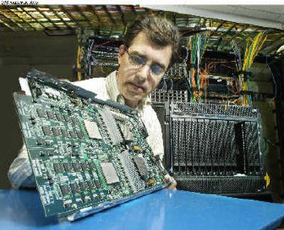 
IBM researcher Ronald Ridgeway examines a new IBM computer previewed in New York on Wednesday. 
 (Associated Press / The Spokesman-Review)