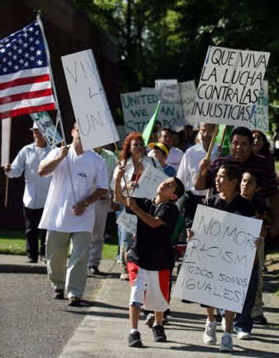 
Marchers make their way to the Bureau of Citizenship and Immigration Services office in Yakima for a protest rally Monday. Yakima County's mostly Hispanic immigrant community has been shaken in recent weeks by rumors of deportations and arrests by the immigration service. 
 (Associated Press / The Spokesman-Review)