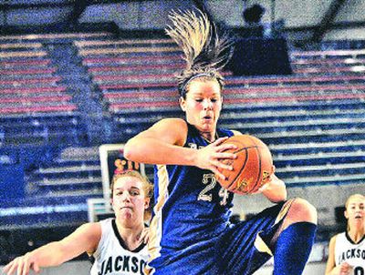 Mead's Kelli Valentine leaps above Michelle Addington, left, for possession of a loose ball against Jackson.  
 (Holly Pickett / The Spokesman-Review)
