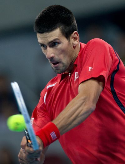 Serbia's Novak Djokovic hits a backhand shot to Florian Mayer during their men's singles semifinal match in the China Open. (Associated Press)