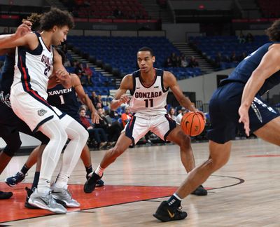 Gonzaga guard Nolan Hickman (11) dashes through traffic against Xavier in the game for third place in the Phil Knight Legacy tournament in the Veterans Memorial Coliseum in Portland, Oregon Sunday, Nov 27, 0222 Oregon Sunday, Nov. 27, 2022. Gonzaga won 88-84.  (Jesse Tinsley / The Spokesman-Review)