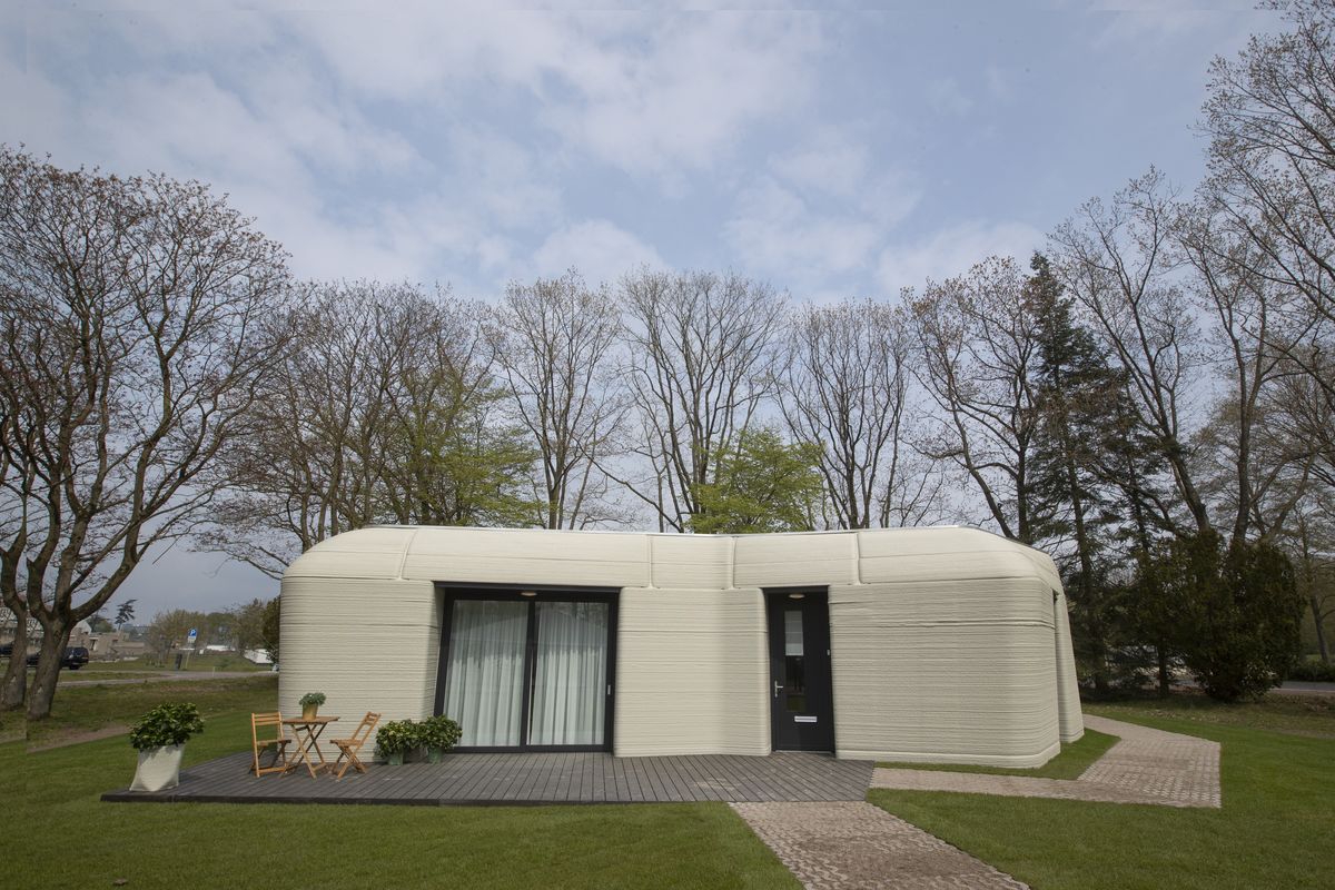 Exterior view showing the printer layers of the 3D-printed 94-square meters (1,011-square feet) two-bedroom bungalow resembling a boulder with windows in Eindhoven, Netherlands, Friday, April 30, 2021. The fluid, curving lines of its gray walls look natural. But they are actually at the cutting edge of housing construction in the Netherlands and around the world. They were 3D printed at a nearby factory.  (Peter Dejong)