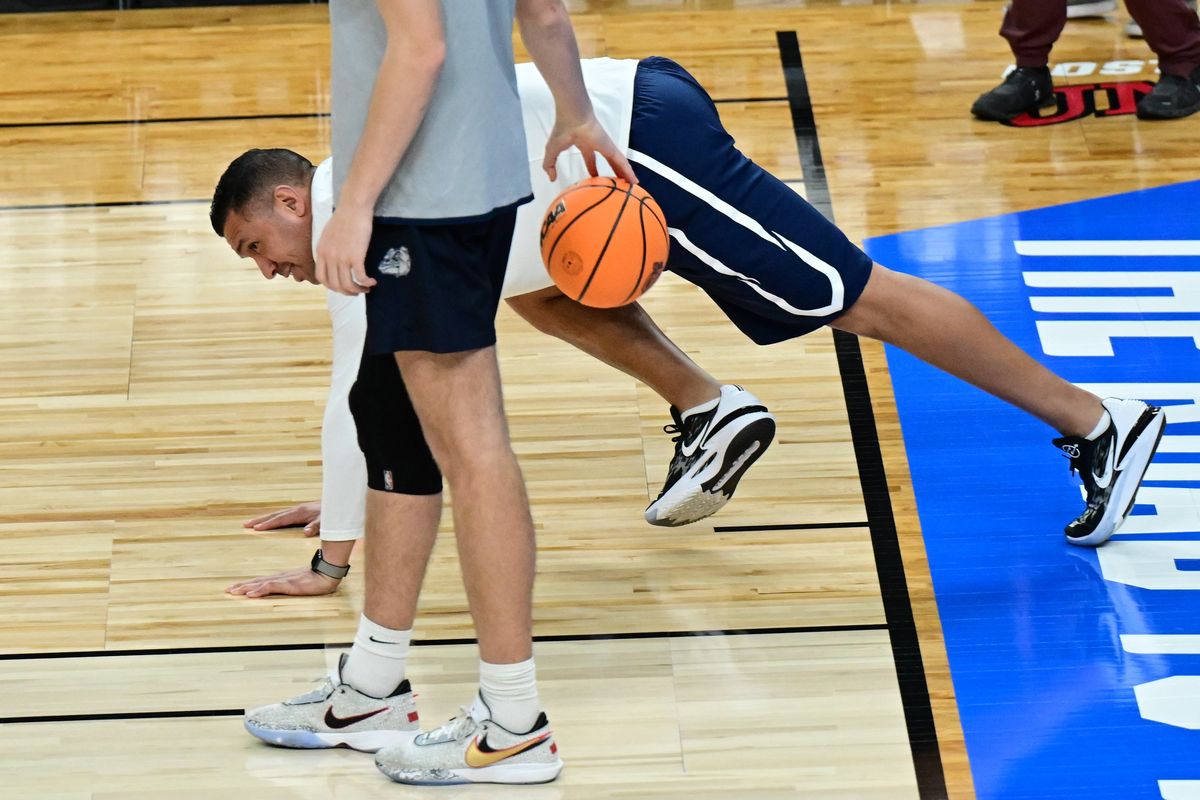 Gonzaga graduate assistant J.P. Batista smiles after finishing a round of pushups after losing a free-throw competition to the bigs at Wednesday’s practice at T-Mobile Arena.  (By Tyler Tjomsland/The Spokesman-Review)