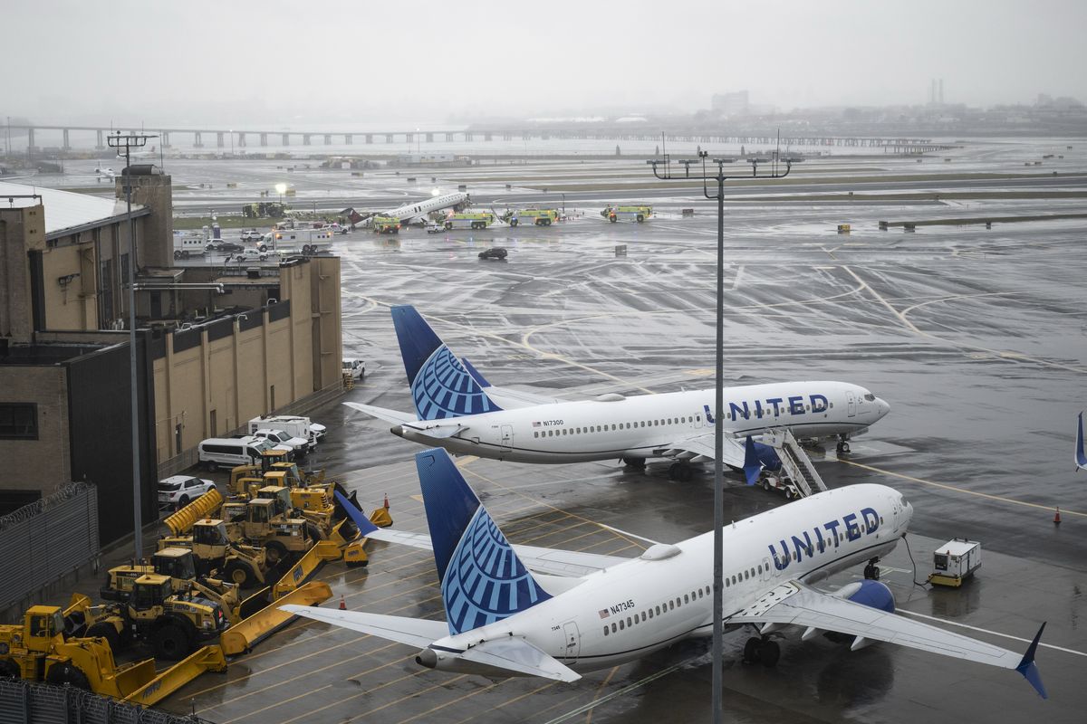 The wreckage of an Air Canada regional jet and a Port Authority fire truck on the runway at LaGuardia Airport in Queens, on Monday, March 23, 2026. A runway collision at New York