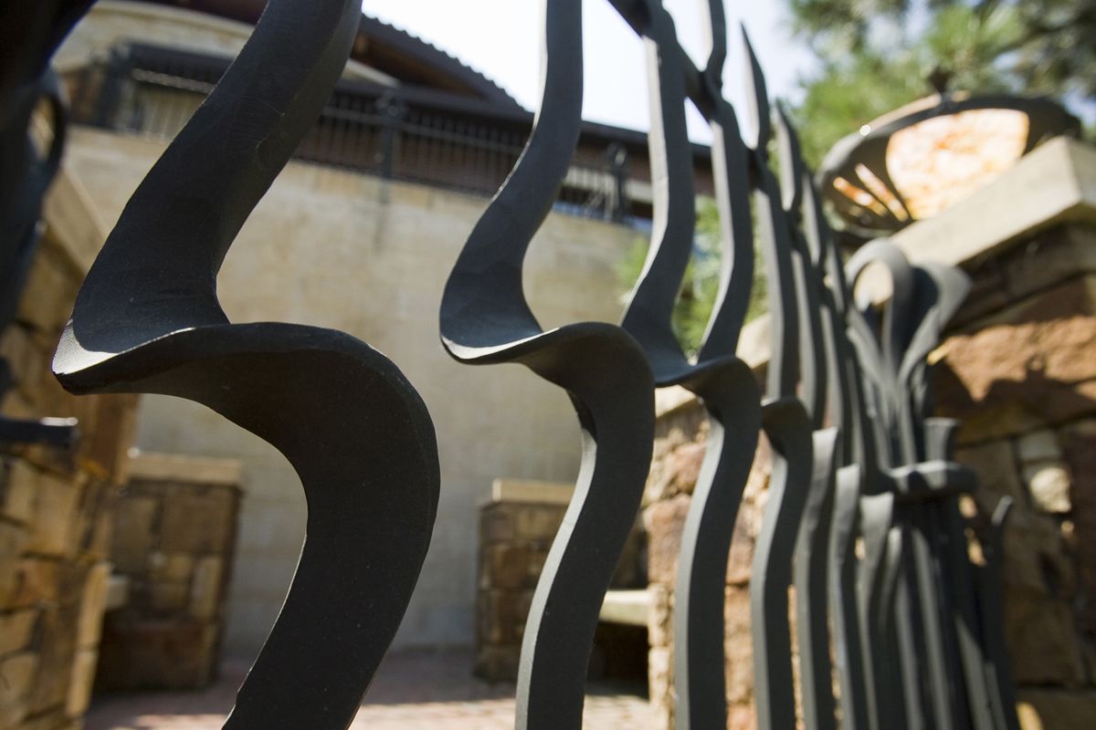 Artistic bends are featured in the gate of a bronze fence in Kansas City’s Sunset Hill neighborhood. 