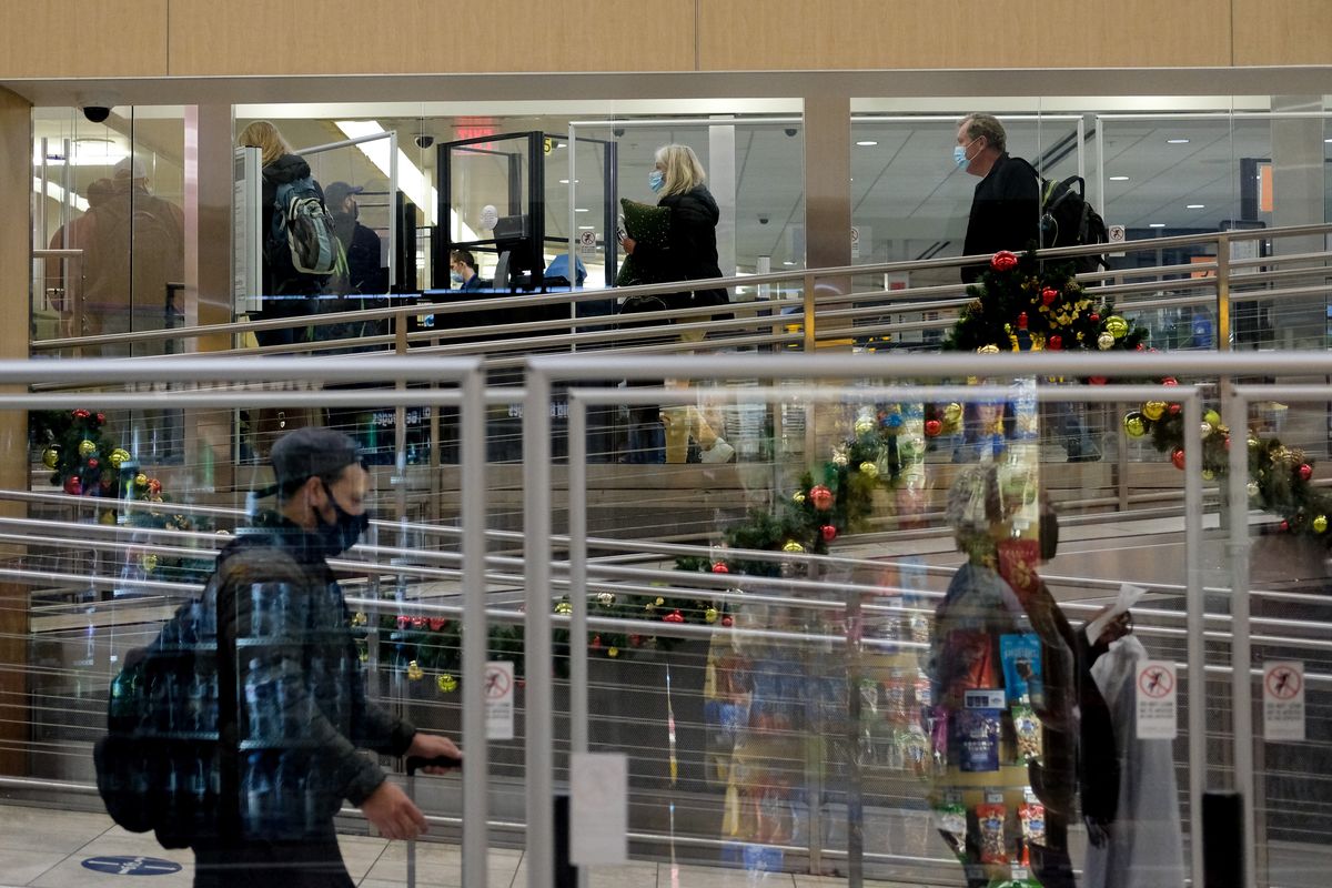 Travelers head through a TSA checkpoint on Thursday, Nov. 18, 2021, at Spokane International Airport.  (Tyler Tjomsland/The Spokesman-Review)