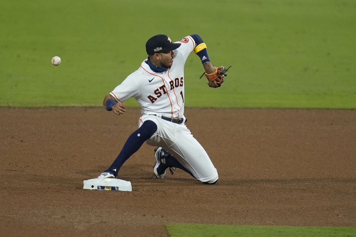 Houston Astros shortstop Carlos Correa misses a throw from Houston Astros