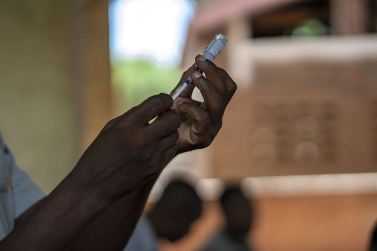 FILE - In this file photo taken Wednesday, Dec. 11, 2019, health officials prepare to vaccine residents of the Malawi village of Tomali, where young children become test subjects for the world