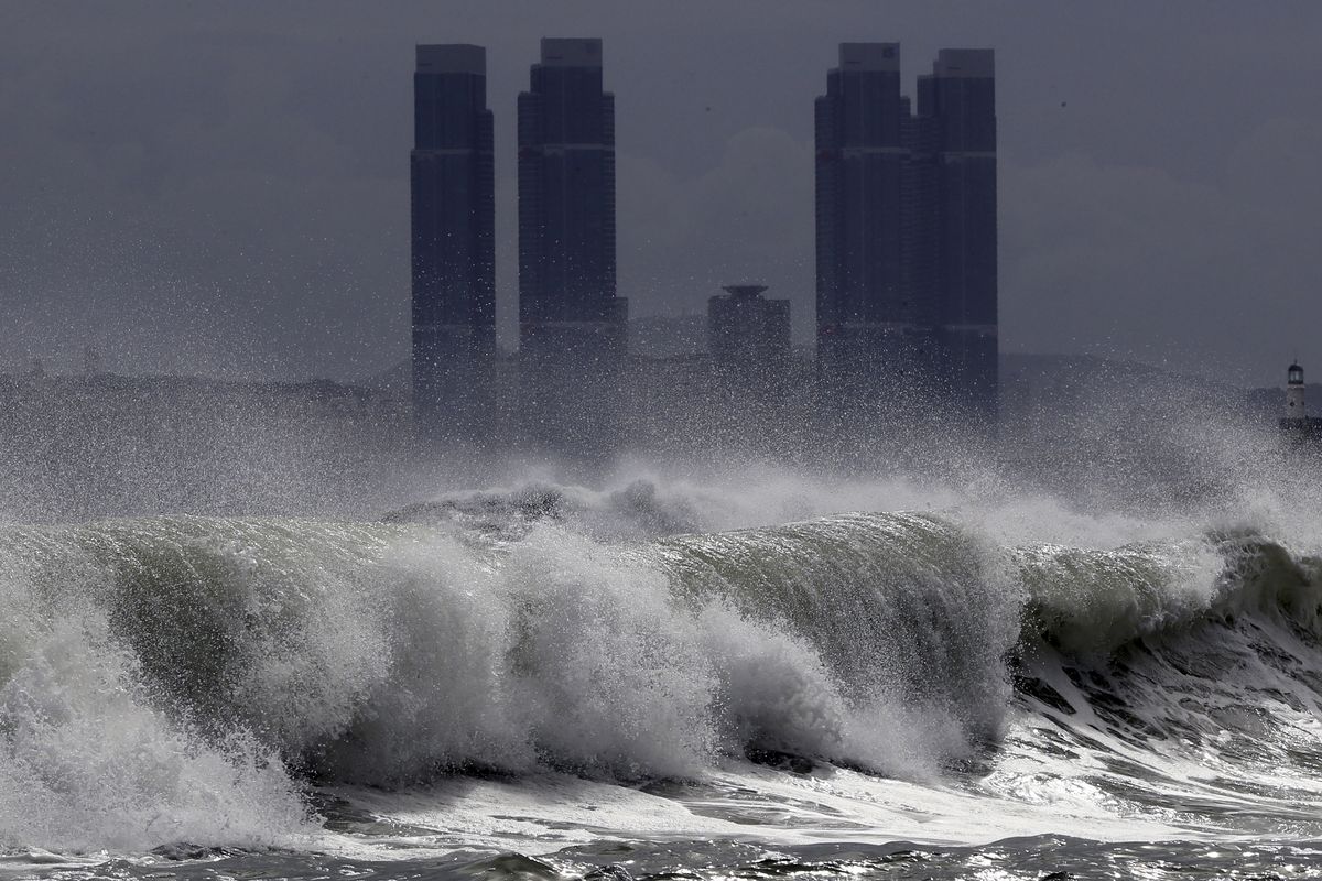 High waves crash onto Haeundae Beach in Busan, South Korea, Wednesday, Aug. 26, 2020, as Typhoon Bavi approaches the Korean Peninsula. Hundreds of flights were canceled in South Korea while North Korea
