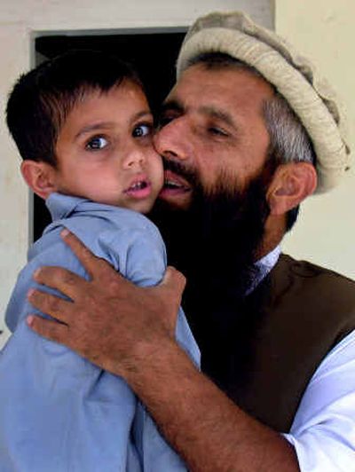 
 Abdul Rahim Muslim Dost, 42, who was released from Guantanamo Bay prison, kisses his son Abdul Karim at his residence Saturday in Peshawar, Pakistan.
 (Associated Press / The Spokesman-Review)