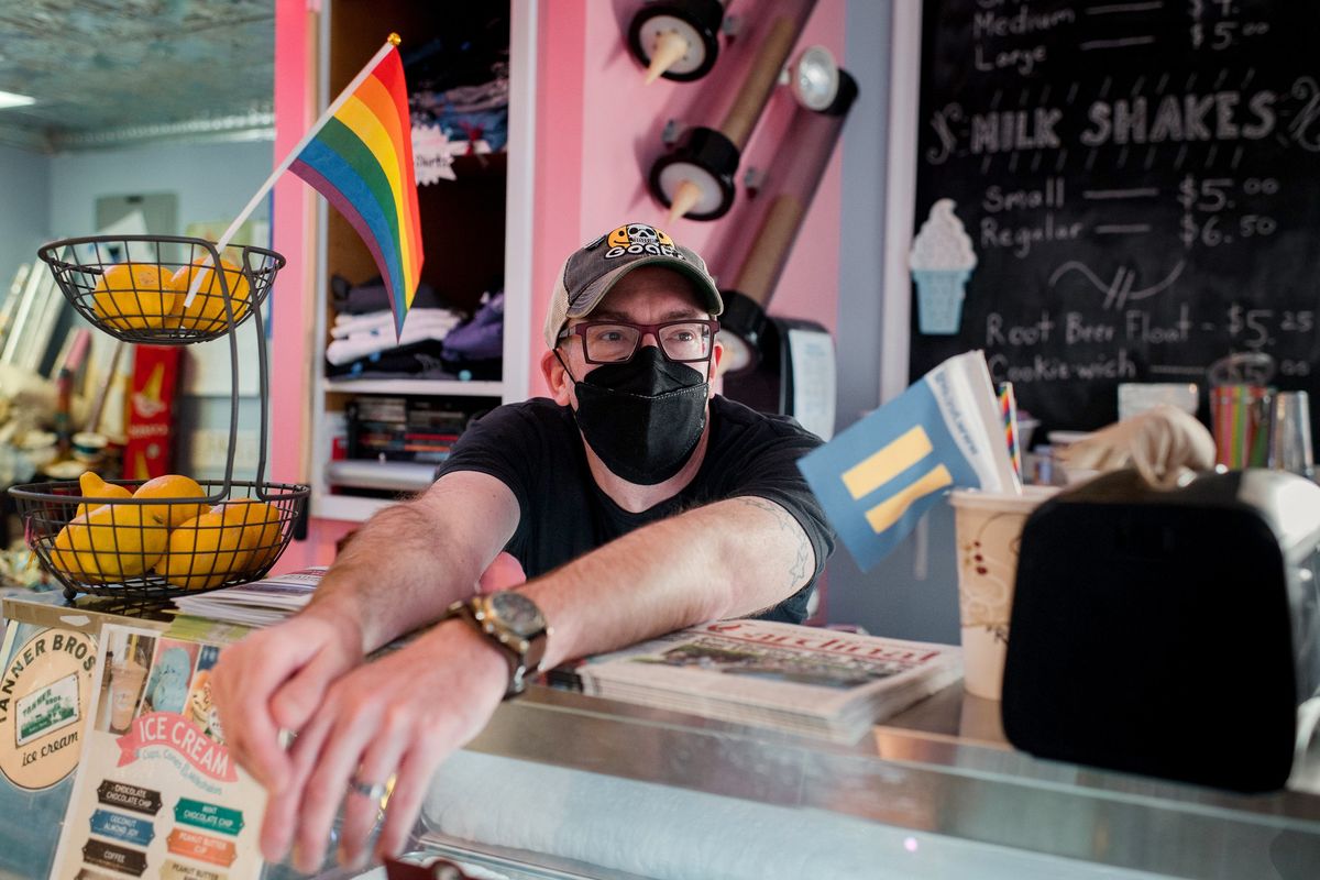 Owner of Evolution Candy, James Lamb, 43, takes a break inside the shop in Doylestown, Pa. (Hannah Yoon/The Washington Post)