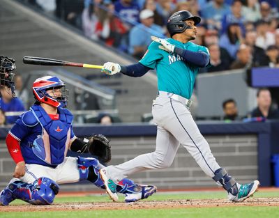 Seattle second baseman Jorge Polanco hits a three-run home run in the fifth inning against Toronto in Game 2 of the American League Championship Series Monday at Rogers Centre in Toronto.  (Jennifer Buchanan/Seattle Times)