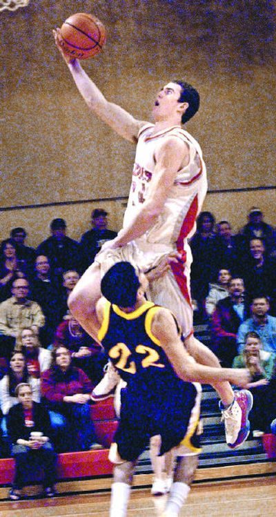 
Ferris' Jared Karstetter leaps over Moses Lake's Tyson Garcia during first-quarter play Tuesday.
 (Brian Plonka / The Spokesman-Review)