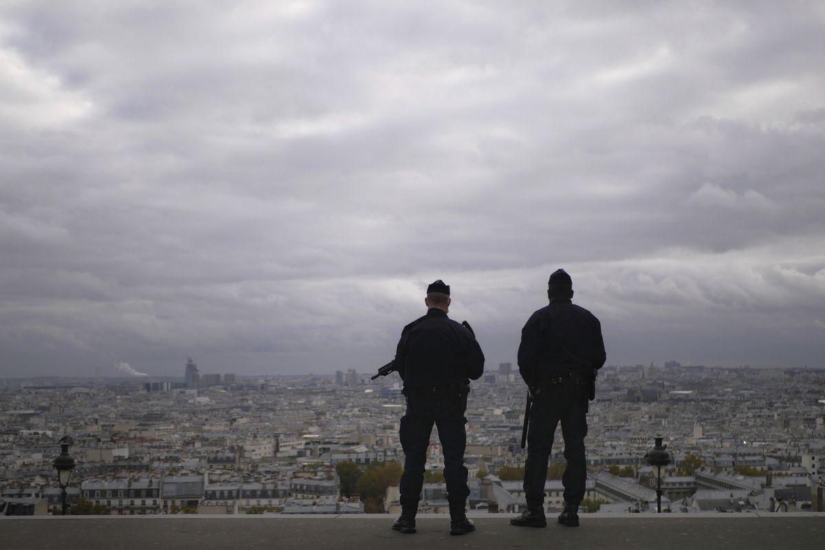 In this Oct. 30, 2020 photo, police officers stand guard next to the Sacre Coeur basilica in Paris, following an attack at a church in the Mediterranean city of Nice. Scrubbing France clean of radicals and their breeding grounds is a priority cause of President Emmanuel Macron in a nation bloodied by terror attacks, including the beheading of a teacher outside his school in a Paris suburb followed by a deadly attack inside the basilica in Nice.  (Thibault Camus)