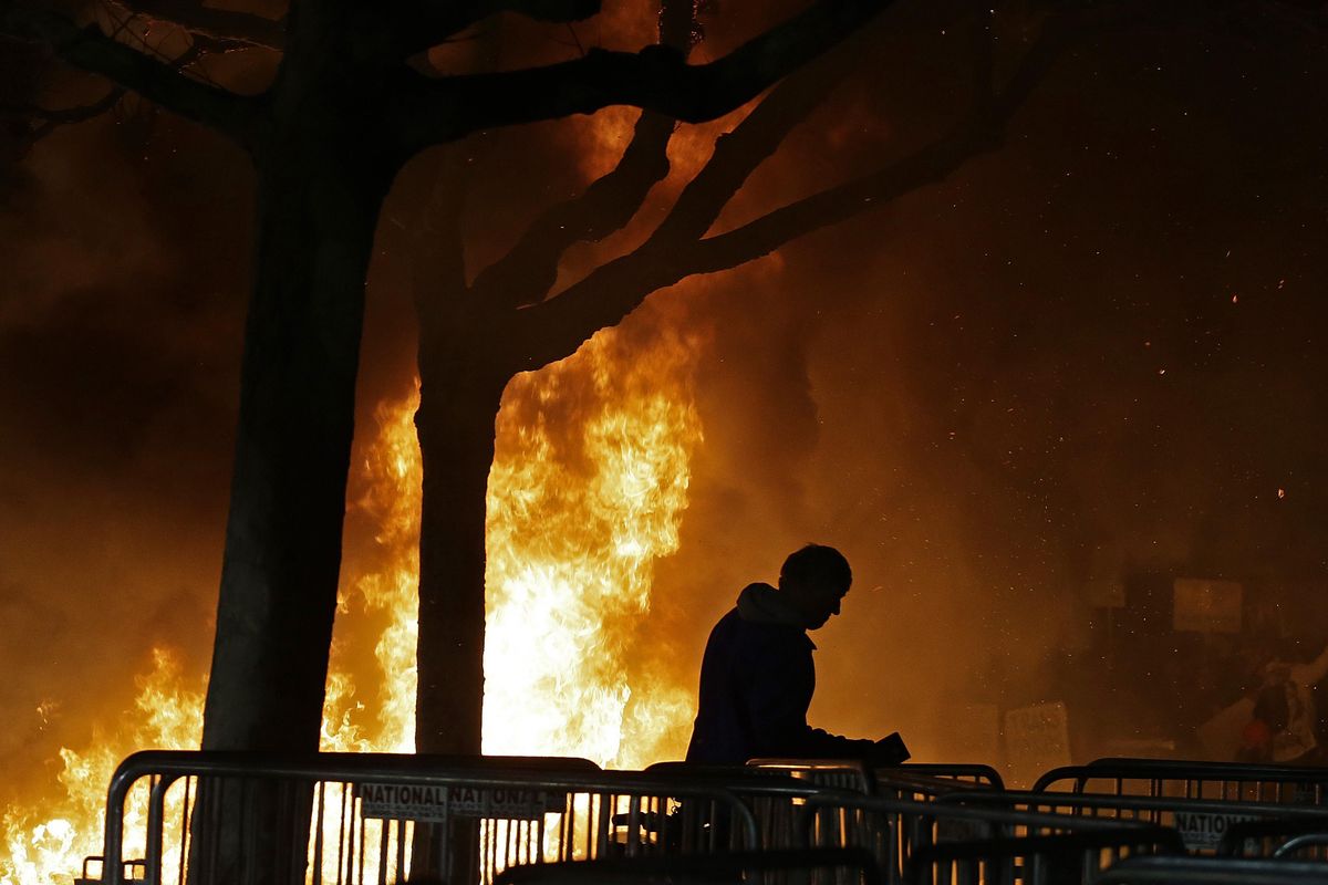 A bonfire set by demonstrators protesting a scheduled speaking appearance by Breitbart News editor Milo Yiannopoulos burns on Sproul Plaza on the University of California at Berkeley campus on Wednesday, Feb. 1, 2017, in Berkeley, Calif. The event was canceled out of safety concerns after protesters hurled smoke bombs, broke windows and started a bonfire. (Ben Margot / AP)