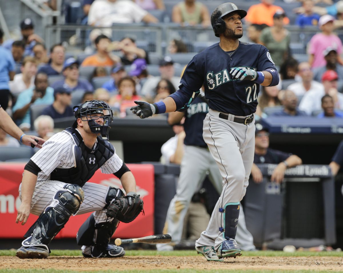 Mariners 2B Robinson Cano, right, and Yankees C Brian McCann watch a ball hit by Cano for a two run home run during the sixth inning on Saturday. (AP)