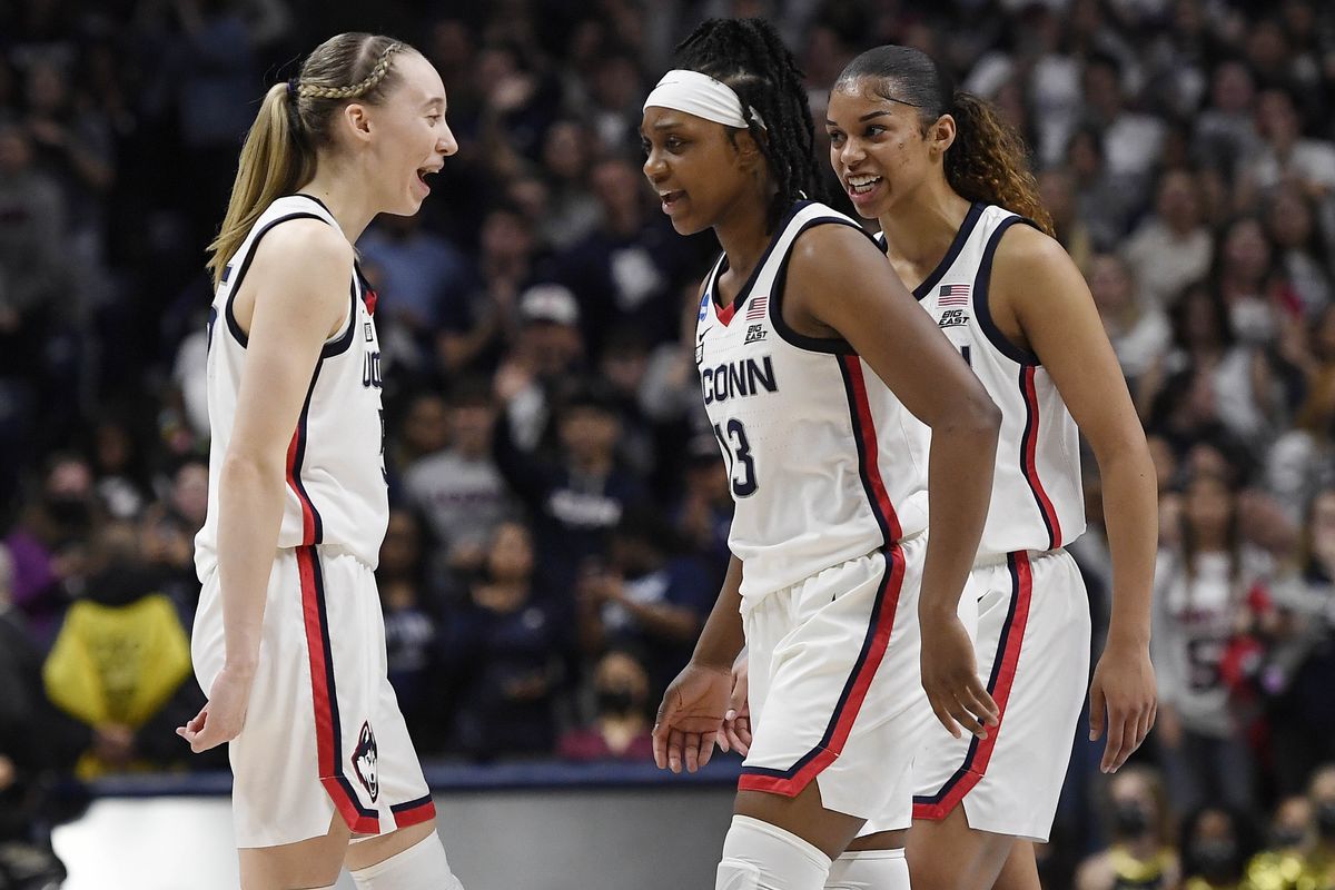 Connecticut’s Paige Bueckers, left, Christyn Williams and Evina Westbrook take a break against Central Florida last Monday. (Jessica Hill)