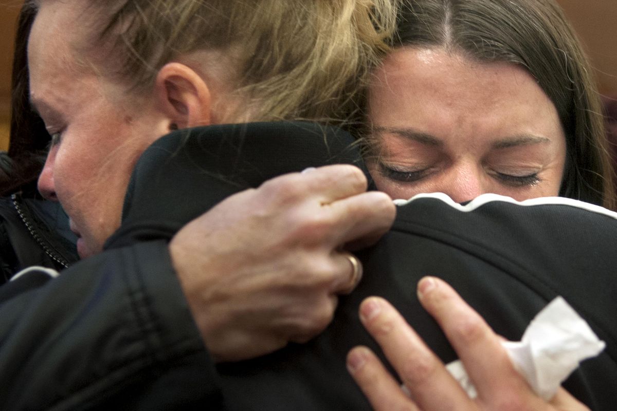 Sgt. Greg Moore’s widow Lindy Moore, right, gets a hug from Moore’s ex-wife, Jennifer Brumley, after the jury handed down the death penalty to Jonathan Renfro at the Kootenai County Courthouse on Saturday, Nov. 4, 2017. (Kathy Plonka / The Spokesman-Review)
