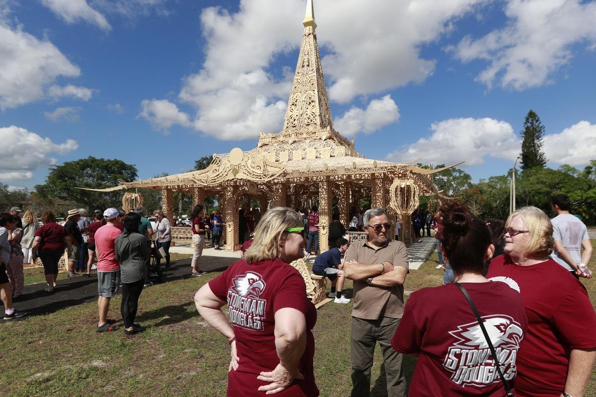 In this Feb. 14, 2019, photo, people gather around the “Temple of Time” in honor of the 17 that were killed during the Marjory Stoneman Douglas High School shooting in 2018 in Coral Springs, Fla. The temple built as a memorial to the 17 victims of a Florida high school mass shooting is to be burned to the ground in a symbolic gesture of healing. (Wilfredo Lee / AP)