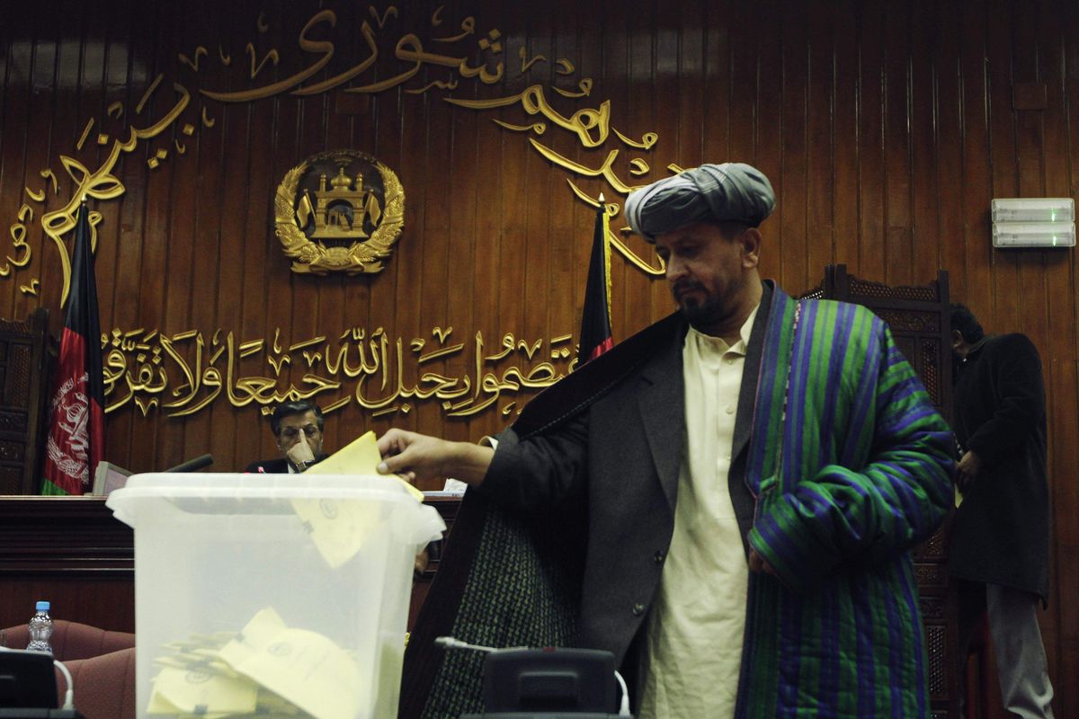 An Afghan parliament member votes  on   Cabinet nominees in Kabul, Afghanistan,  on Saturday. Associated Press photos (Associated Press photos)