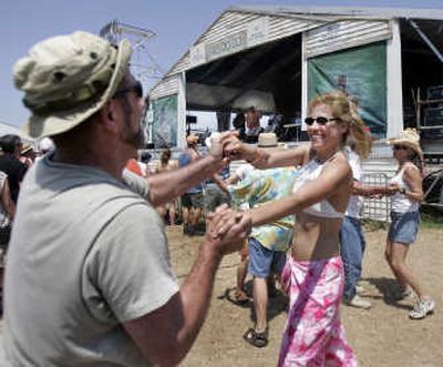 Deidre Lundquist and David Wurtzel dance in front of the Fais Do-Do stage at the 2007 New Orleans Jazz and Heritage Festival.Associated Press file photos
(Associated Press file photos / The Spokesman-Review)