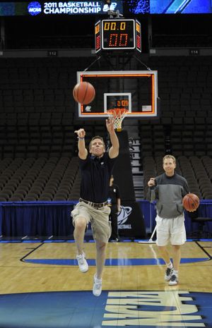 Up and away: As assistant coach Ray Giacoletti watches, Gonzaga men’s coach Mark Few launches a half-court shot at the end of practice Wednesday at the Pepsi Center in Denver. The Zags meet St. John’s tonight to open the NCAA Tournament. Preview in Sports, B1 (Dan Pelle / The Spokesman-Review)