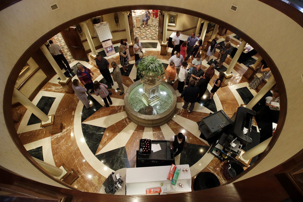 Guests gather in the rotunda as they wait for the wedding of Danessa Molinder and Billy Castrodale at the Community Life Center in Indianapolis on June 19. The center, which has hosted several events in an effort to add revenue, sits on cemetery land near a funeral home. (Associated Press)