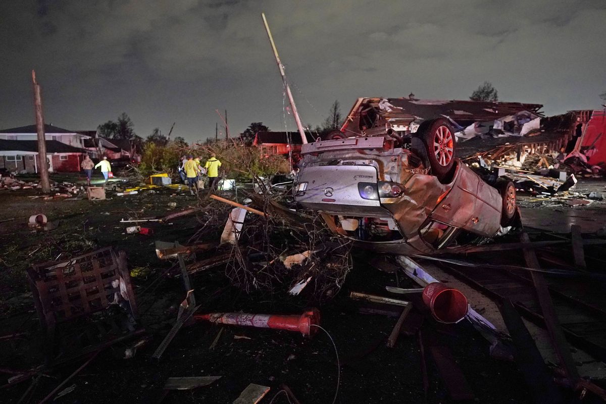 FILE - A car is flipped over after a tornado tore through the area in Arabi, La., Tuesday, March 22, 2022, in a part of the city that had been heavily damaged by Hurricane Katrina 17 years earlier. A United Nations report released on Monday, April 25, 2022, says disasters are on the rise are just going to get worse. A new UN report says the number of disasters, from climate change to COVID-19, are going to jump to about 560 a year by 2030.  (Gerald Herbert)