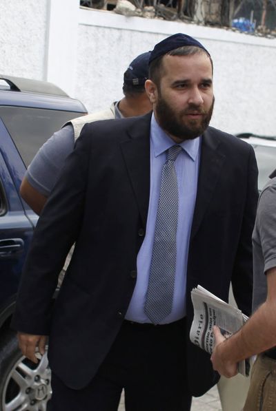 In this photo taken Feb. 8, 2010, Jorge Puello, left, a Dominican legal adviser, who was hired by the relatives of the 10 Americans that were arrested while trying to bus children out of Haiti without proper documents or government permission, arrives to the court building in Port-au-Prince.  (Associated Press)