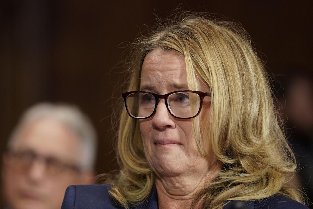 Christine Blasey Ford becomes emotional as she listens to Sen. Cory Booker, D-N.J., as she testifies before the Senate Judiciary Committee on Capitol Hill in Washington, Thursday, Sept. 27, 2018. (Andrew Harnik / Associated Press)