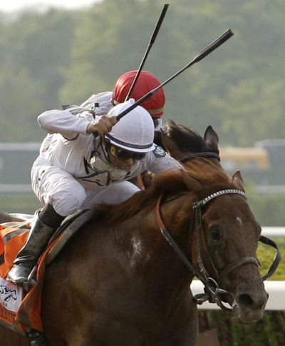 Jockey Mike Smith guides Drosselmeyer, sent off at odds of 13-1, to victory at the 142nd running of the Belmont Stakes on Saturday.  (Associated Press)