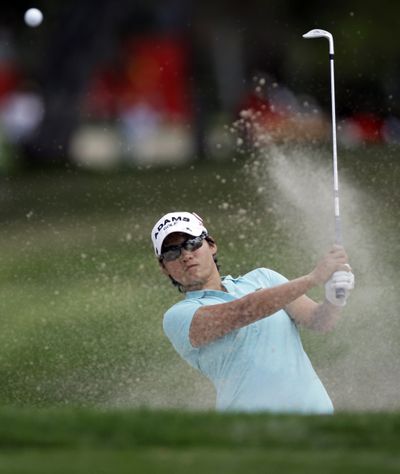 Defending champion Yani Tseng hits from a bunker to the first green during the third round of the LPGA Kraft Nabisco. (Associated Press)