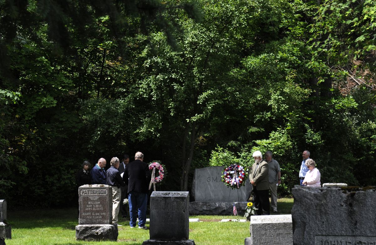 A group gathers around the graves of William Smart and his family at Greenwood Memorial Terrace on Saturday to honor Smart, whose daughter, Sonora Smart Dodd, created a special day in honor of her father  that would become Father’s Day. (PHOTOS BY JESSE TINSLEY / The Spokesman-Review)