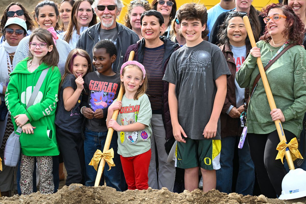 Adams Elementary School Principal Beth Nye, center, is surrounded with current and past students and staff as they gather for a group shot after a groundbreaking ceremony at the site of the new Adams school on Thursday in Spokane.  (DAN PELLE/FOR THE SPOKESMAN-REVIEW)