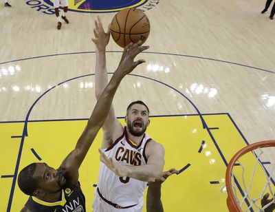 In this June 3, 2018, file photo, Cleveland Cavaliers forward Kevin Love, center, shoots against Golden State Warriors forward Kevin Durant during the first half of Game 2 of basketball's NBA Finals in Oakland, Calif. All-Star forward Kevin Love has signed a new four-year, $120 million contract with the Cleveland Cavaliers, who are beginning anew following LeBron James departure. Love signed the extension Tuesday, July 24, 2018. (Marcio Jose Sanchez / AP)