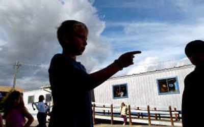 
Students gather outside the portable classrooms at Ramsey Elementary School in Coeur d'Alene on Monday. The classrooms were installed to ease overcrowding. 
 (Kathy Plonka / The Spokesman-Review)
