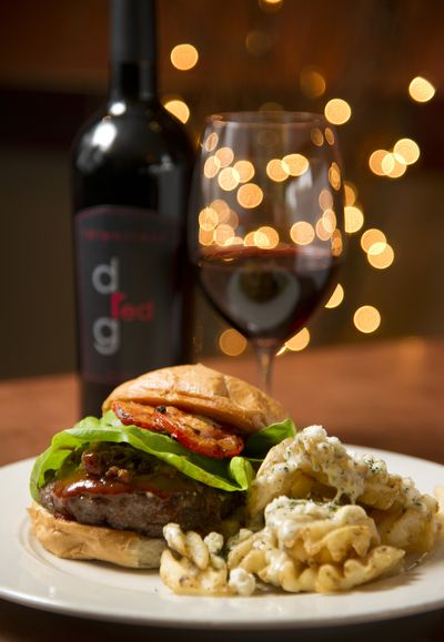 Downriver Grill's DRG Chiipotle BBQ Burger paired with a Relentless Red signature blend house wine. (Colin Mulvany / The Spokesman-Review)
