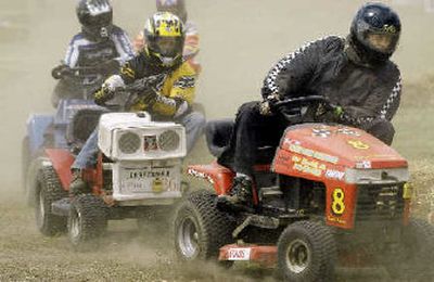 
Tim Klimpke, right, and Art Neaville, center, lean into a turn during their IMOW class race held during the U.S. Lawn Mower Racing Association's STA-BIL Central Illinois Regional competition last Saturday in Mendota, Ill. 
 (Associated Press photos / The Spokesman-Review)