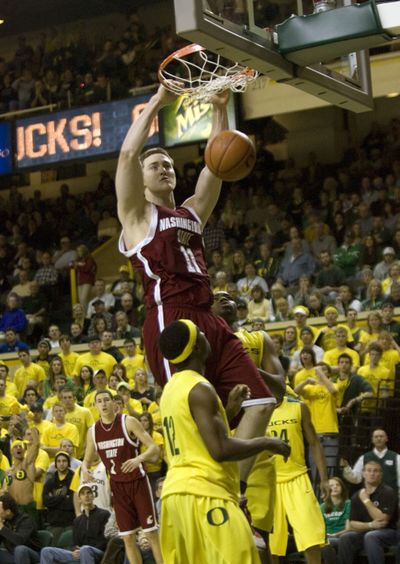 Cougars center Aron Baynes dunks over Oregon guard Tajuan Porter during the second half.  (Associated Press / The Spokesman-Review)